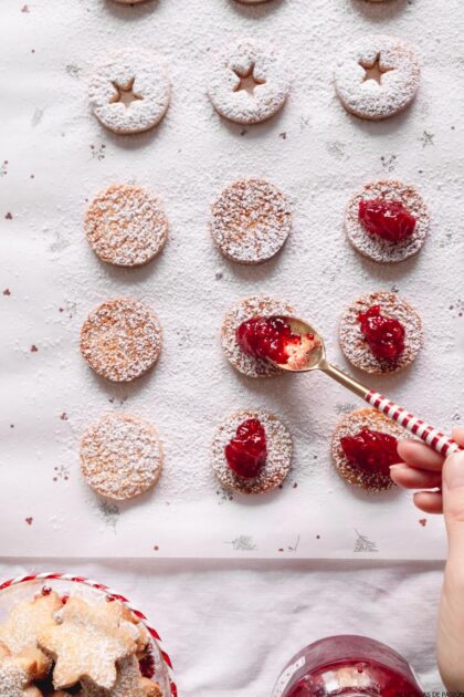 Galletas navideñas con mermelada de frambuesa y azúcar glass.