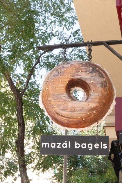 Un cartel que dice Mazal Bagels cuelga del costado de un edificio.